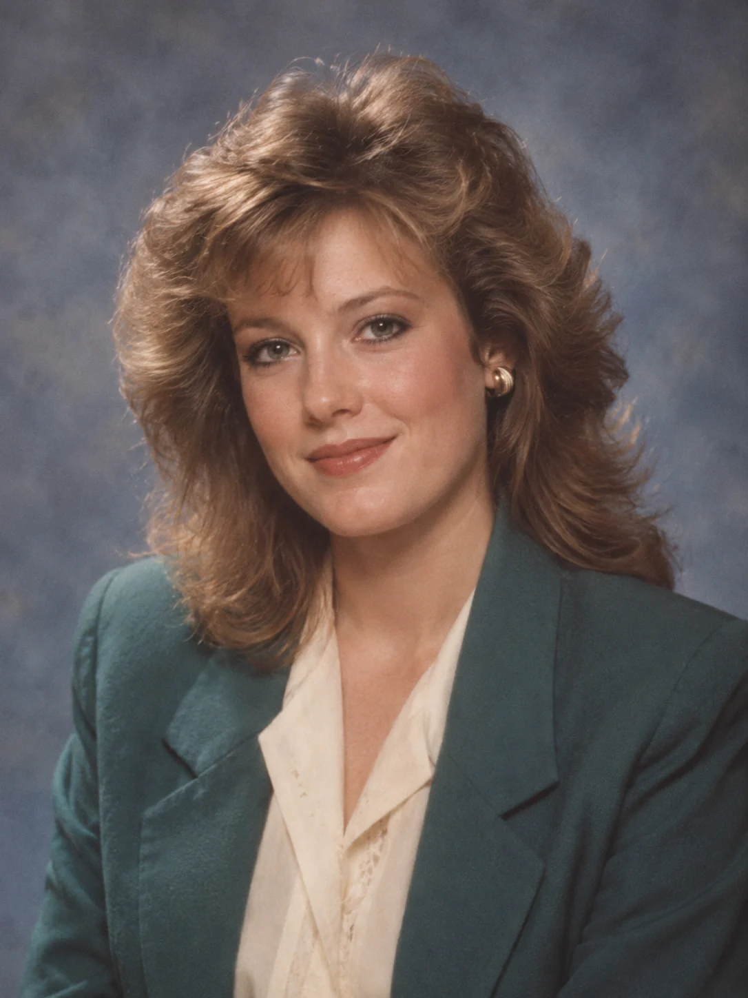 Creative 1985 studio portrait with feathered hair and a teal blazer